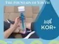 Woman holding a KOR+ water bottle sitting on a brick ground