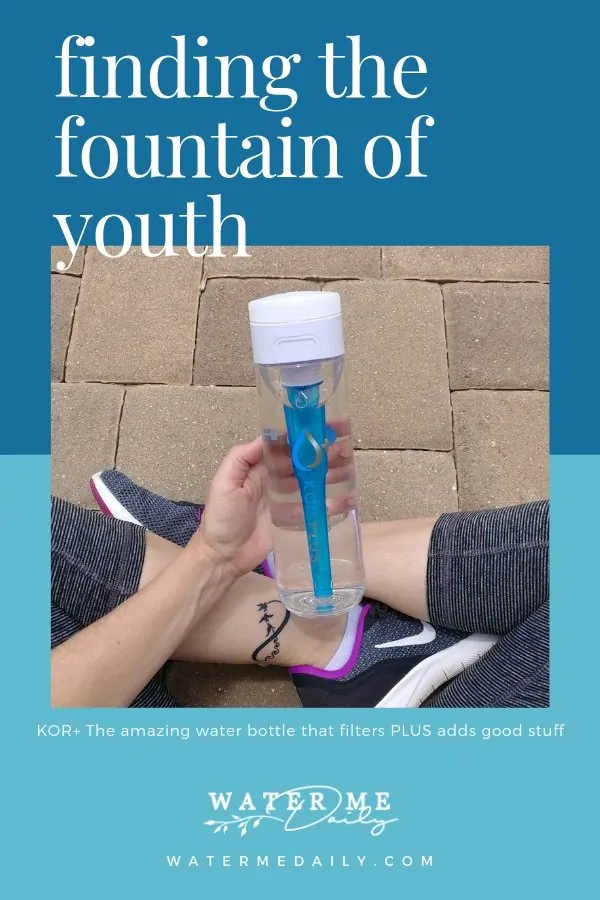 Woman sitting on brick pavers holding KOR+ water bottle