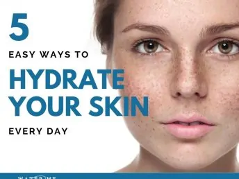 Young woman's face with freckles promoting healthy skin.