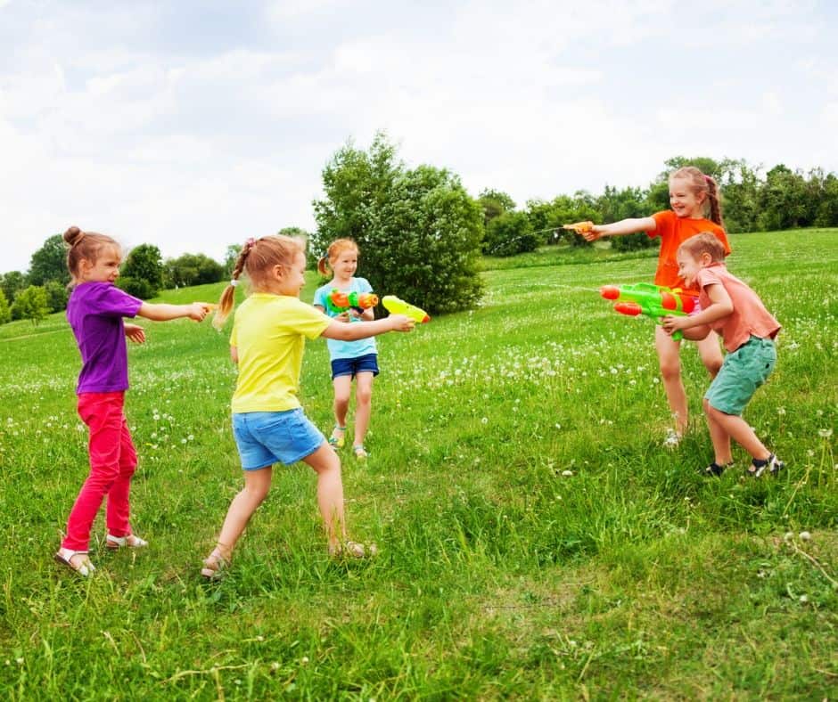Group of kids playing water gun battle.